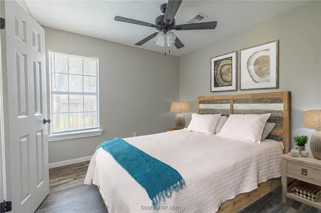 a bedroom with a large bed and a window