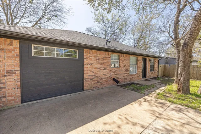 a view of a house with a backyard and trees