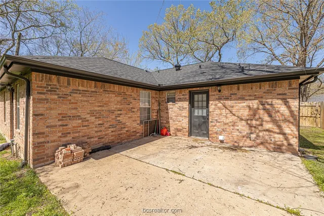 a view of a backyard with wooden fence