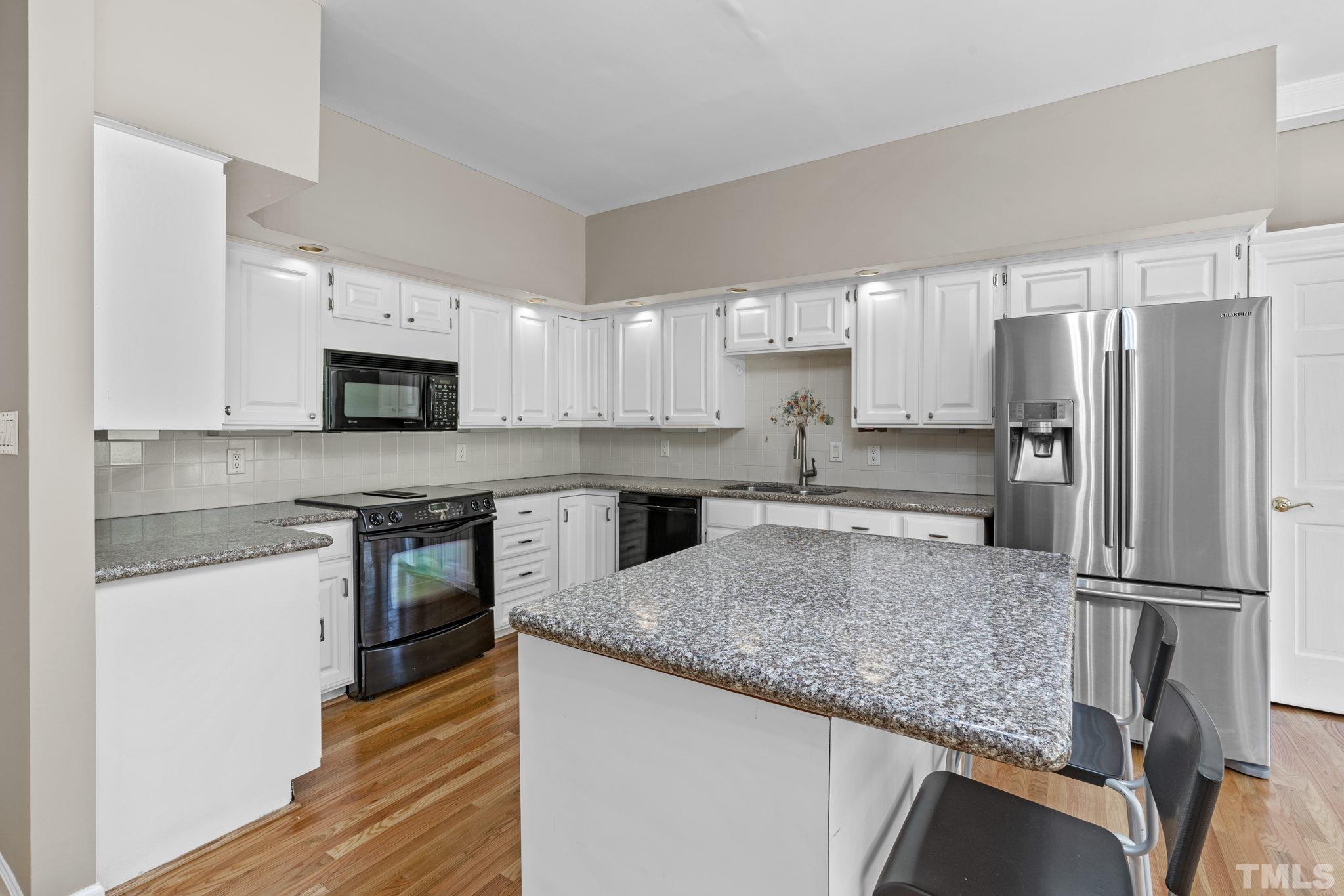 2417 Beechview Court Raleigh, NC 27615 - Photo 14 of 43 a kitchen with stainless steel appliances granite countertop a refrigerator a stove top oven a sink and dishwasher