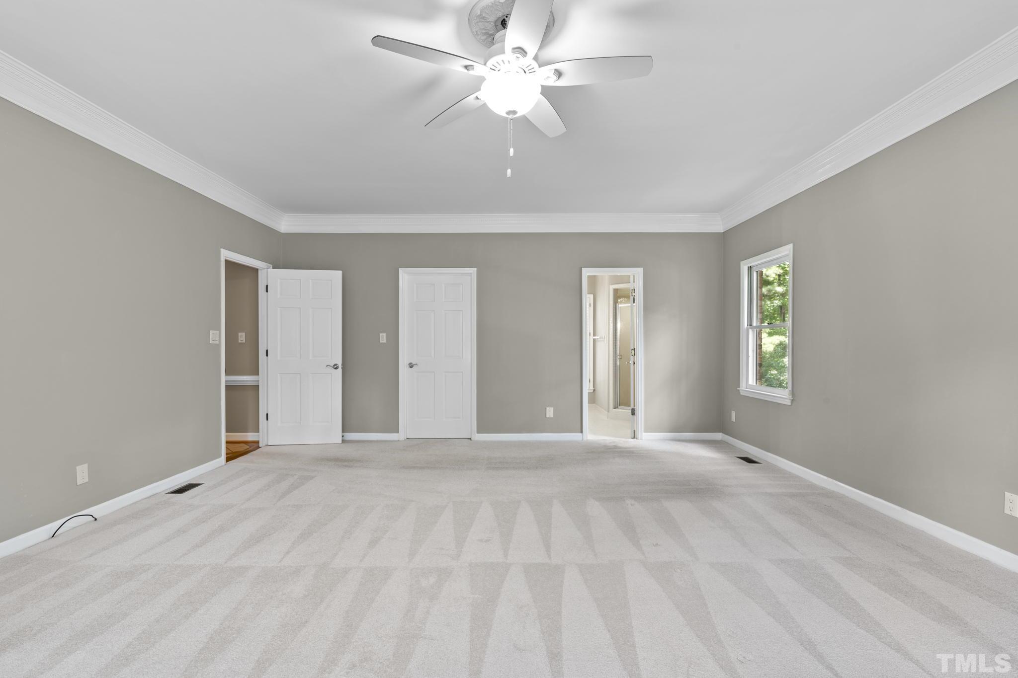 2417 Beechview Court Raleigh, NC 27615 - Photo 19 of 43 a view of an empty room with window and chandelier fan