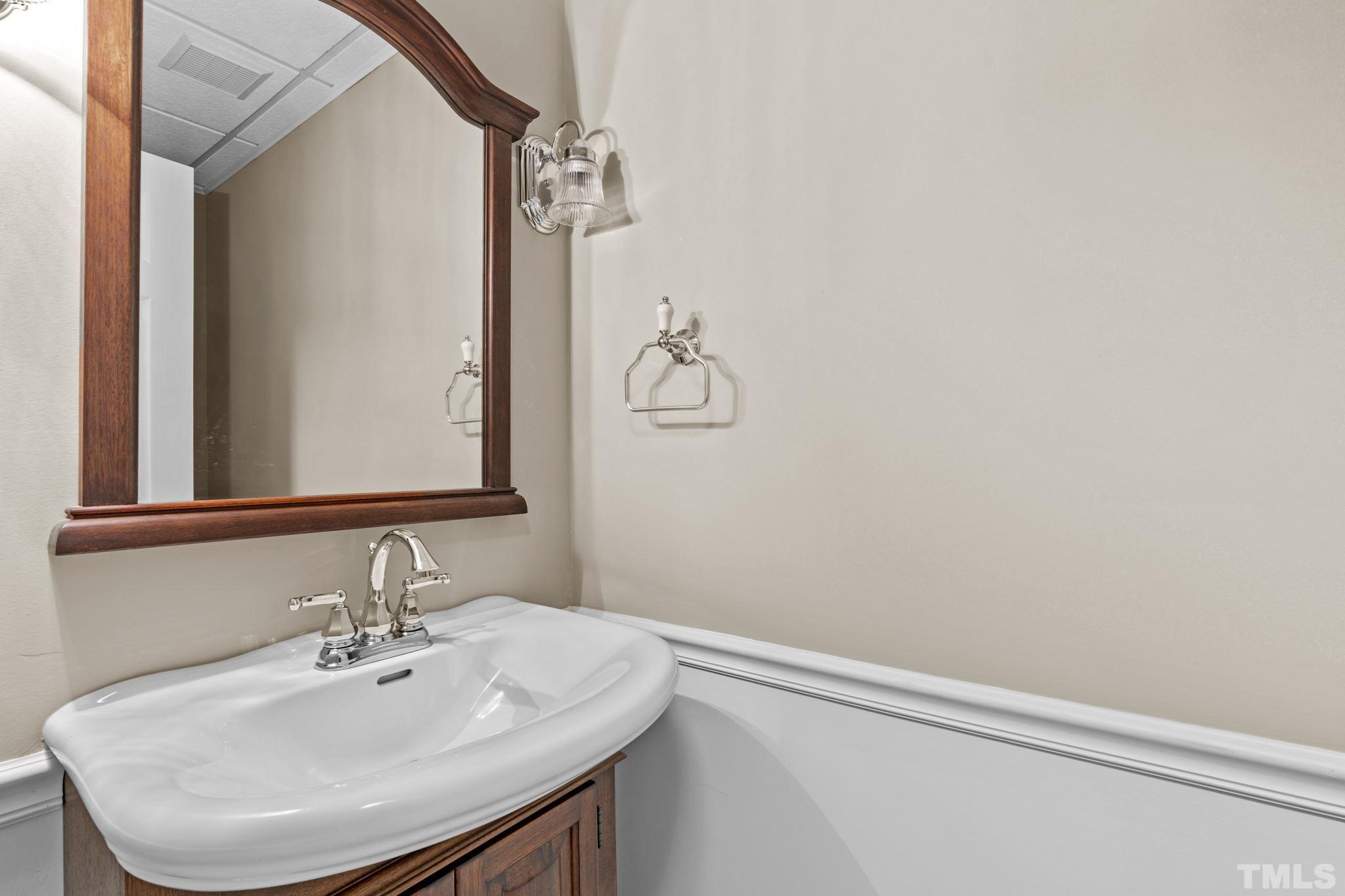 2417 Beechview Court Raleigh, NC 27615 - Photo 34 of 43 a bathroom with a sink and a mirror