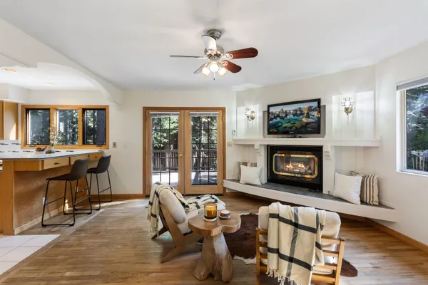 a living room with furniture a fireplace and a flat screen tv