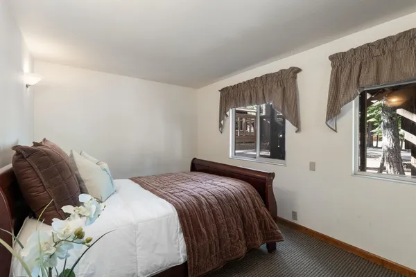 a bed sitting in a bedroom next to a window