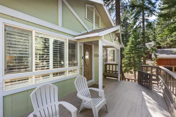a view of a deck with table and chairs and wooden floor