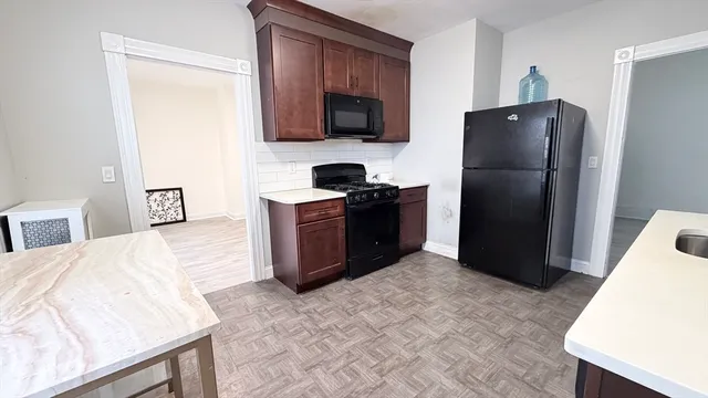 a kitchen with a refrigerator stove and microwave