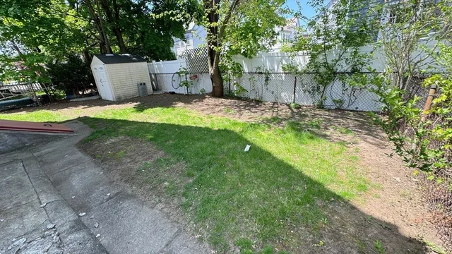 a view of a backyard with swimming pool
