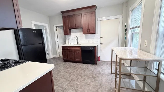 a kitchen with stainless steel appliances a refrigerator and a stove top oven
