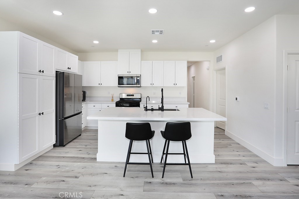 4067 Summer Corona, CA 92883 - Photo 14 of 28 a kitchen with stainless steel appliances a refrigerator and a stove top oven