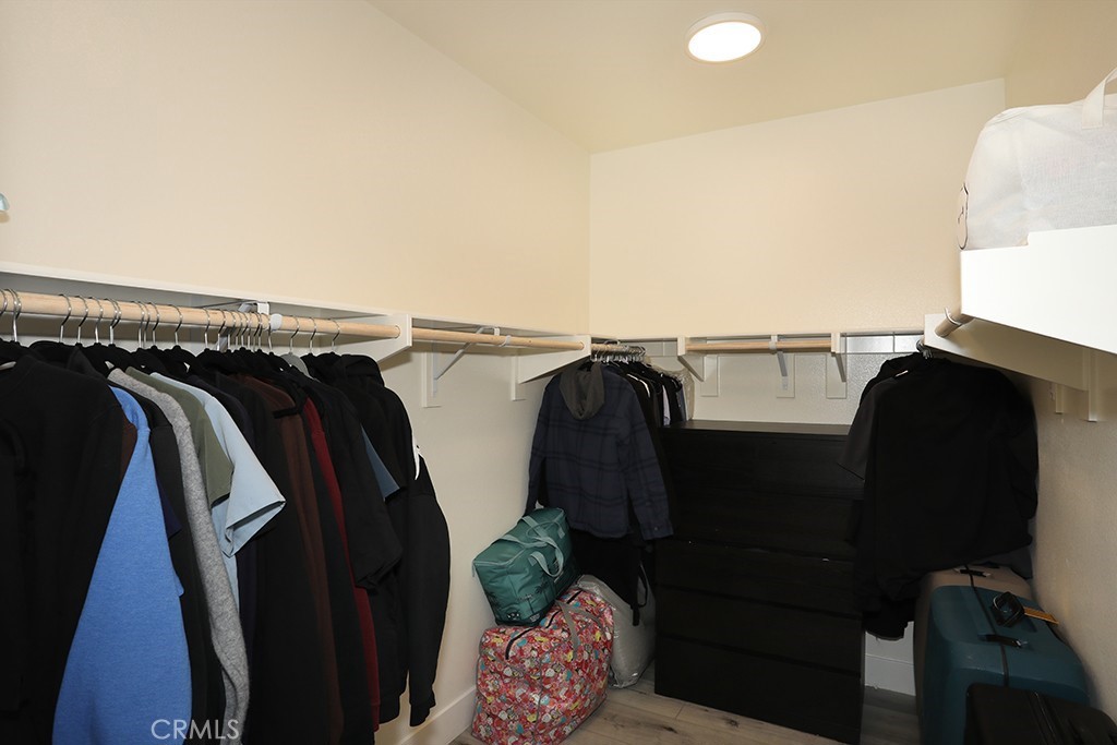 4067 Summer Corona, CA 92883 - Photo 24 of 28 a view of walk in closet with clothes and shoes