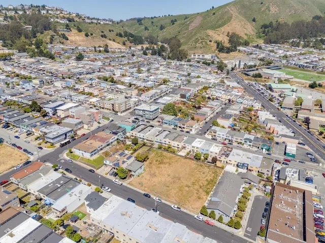 a view of a terrace with a barbeque and wooden stairs