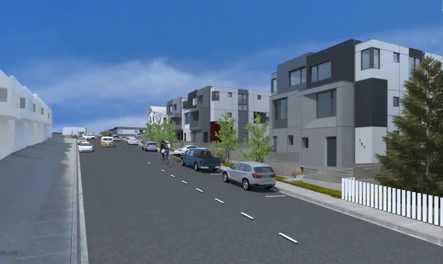 a city street lined with buildings and cars parked on road