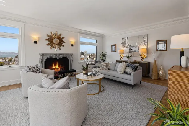 a living room with furniture a fireplace and a flat screen tv