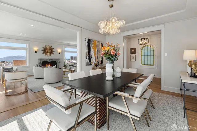 a living room with furniture a chandelier and a flat screen tv