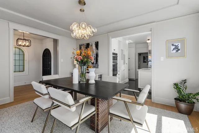 a view of a dining room with furniture and chandelier
