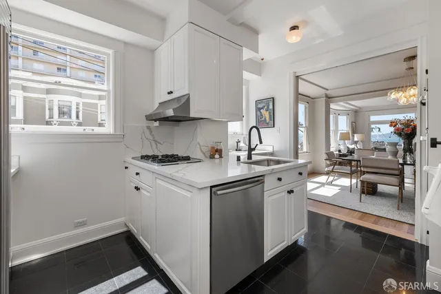a kitchen with a sink stove and cabinets