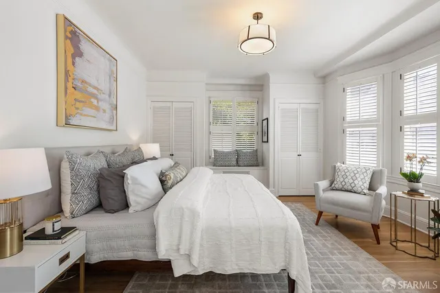 a spacious bedroom with a bed and couch