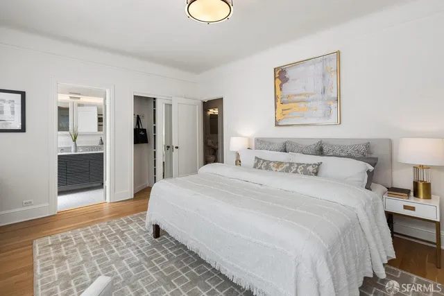 a spacious bedroom with a bed and a table