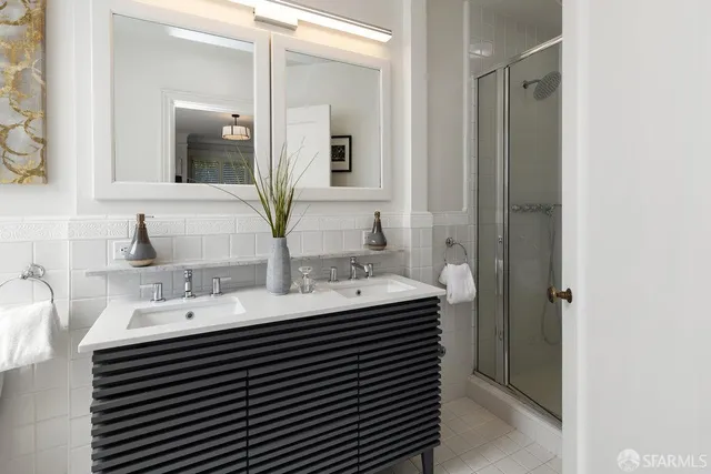 a bathroom with a double vanity sink and a mirror