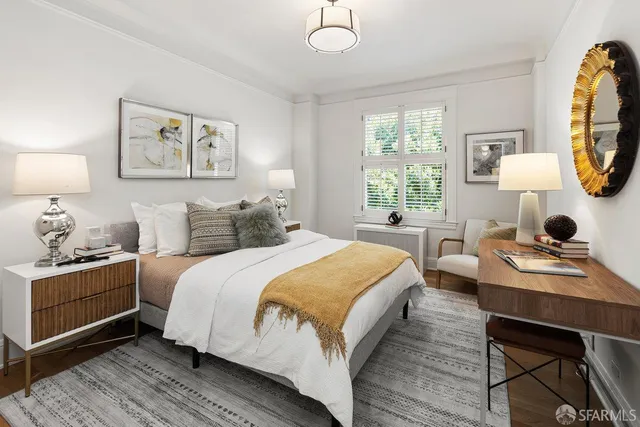 a bedroom with a bed and a desk