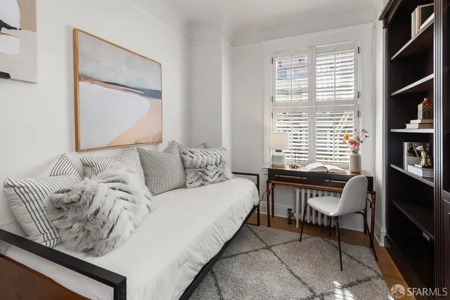 a bed room with a bed and a chair