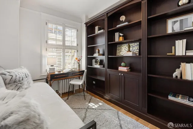 a bedroom with a bed and a bookshelf
