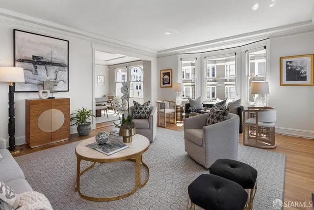 a living room with furniture a rug a lamp and a window