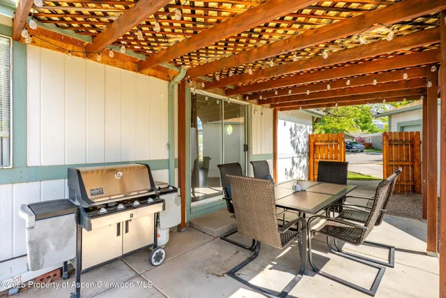 a work room with furniture and a floor to ceiling window