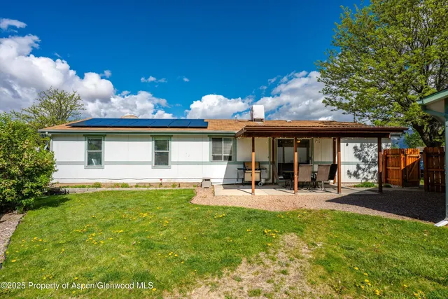 a front view of a house with swimming pool and sitting area