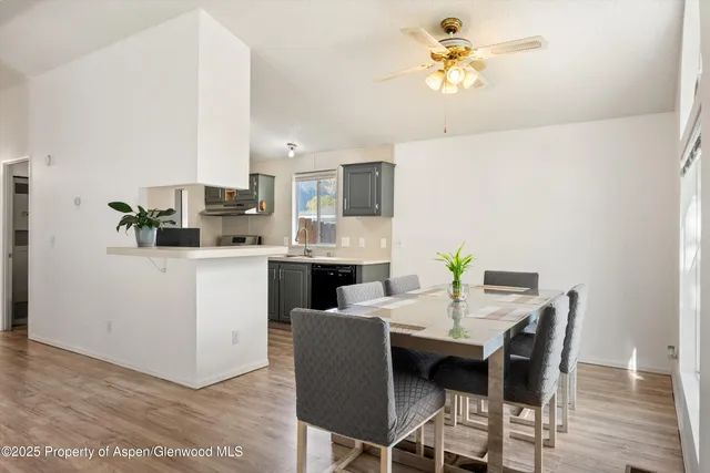 a view of a dining room with furniture and chandelier
