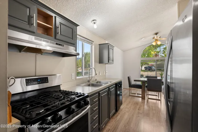 a kitchen with stainless steel appliances granite countertop a stove and a refrigerator
