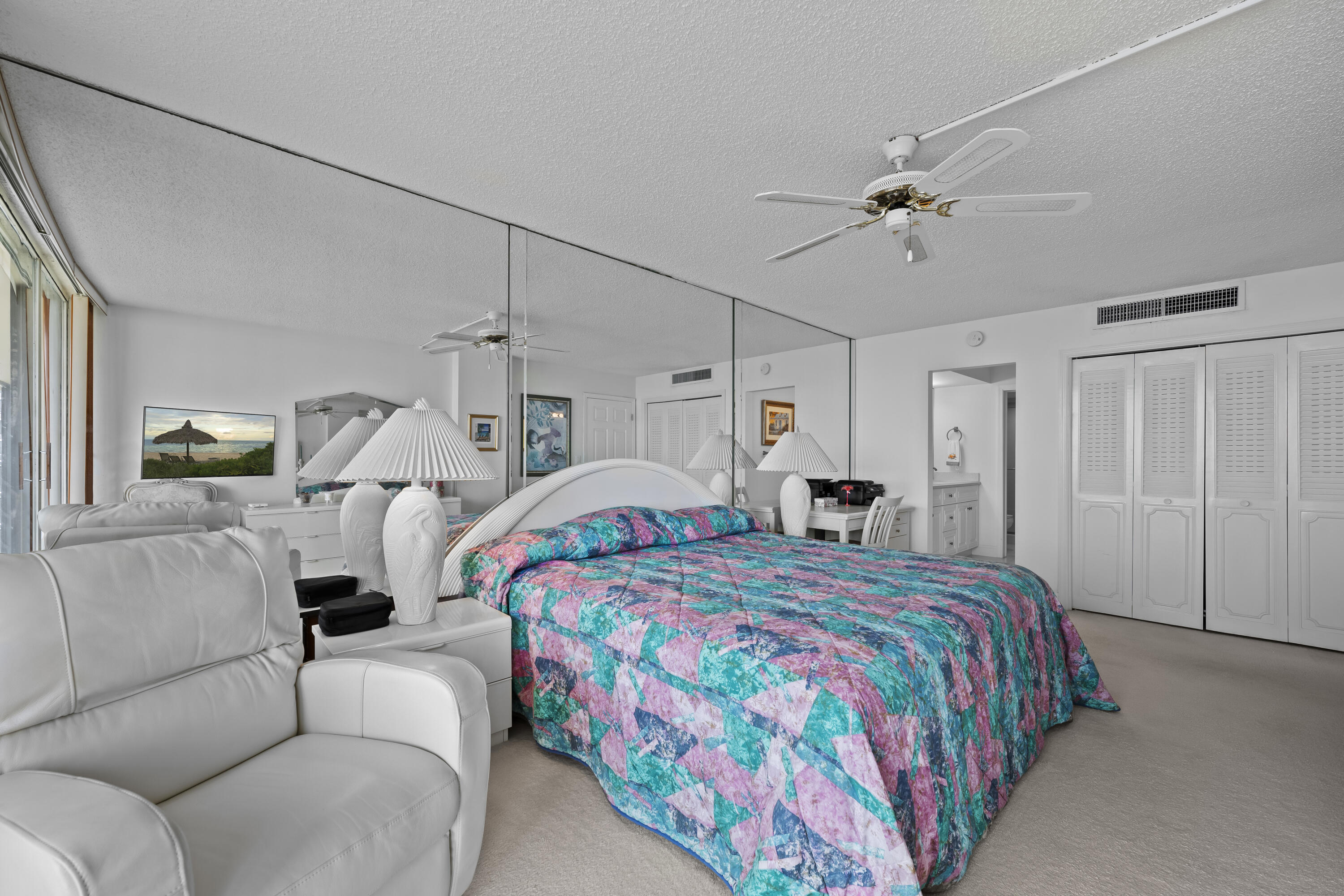 134 Lakeshore Drive, Unit 814 North Palm Beach, FL 33408 - Photo 13 of 30 a bedroom with a bed and a chandelier