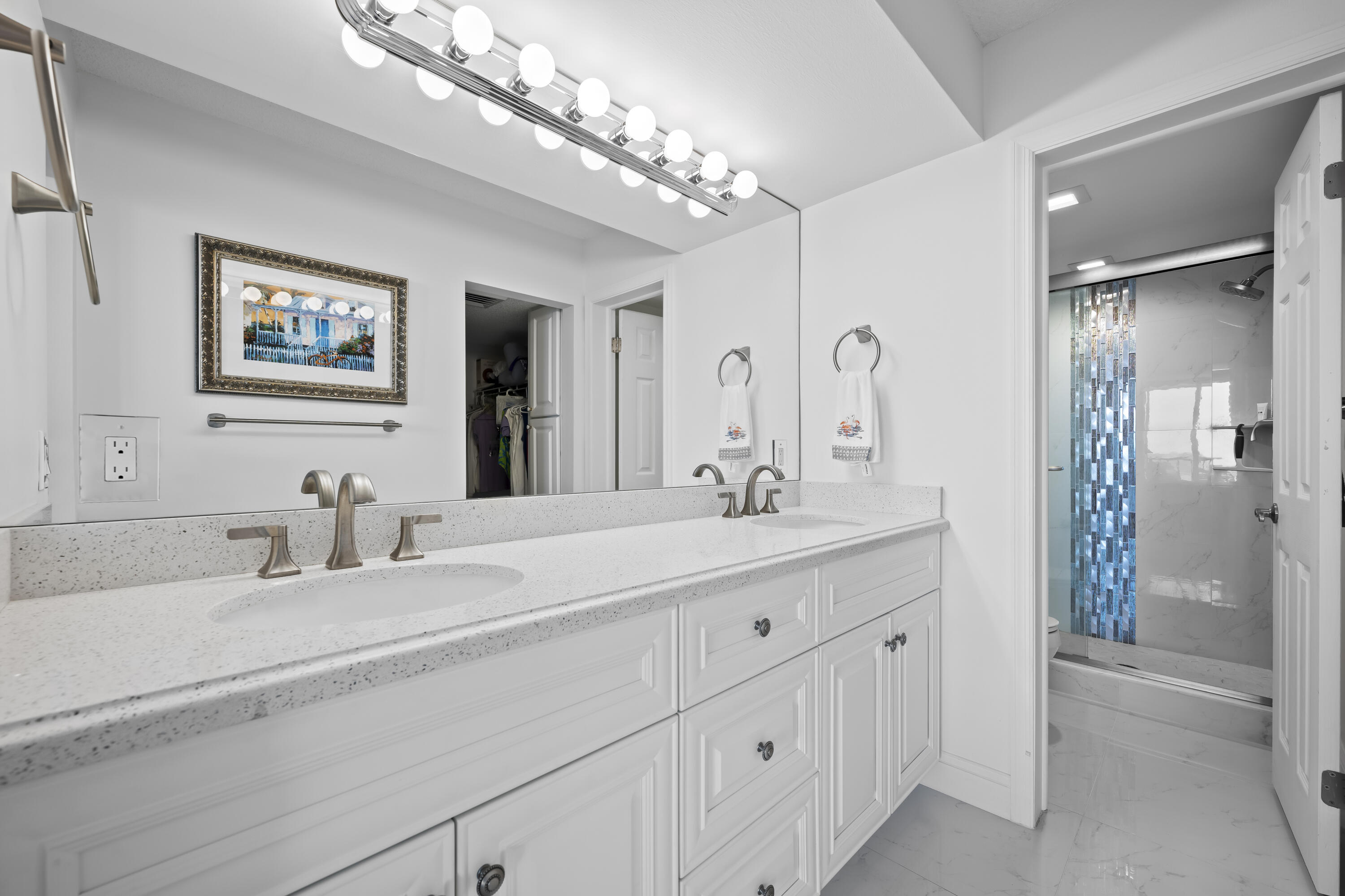 134 Lakeshore Drive, Unit 814 North Palm Beach, FL 33408 - Photo 14 of 30 a bathroom with a sink double vanity and a mirror