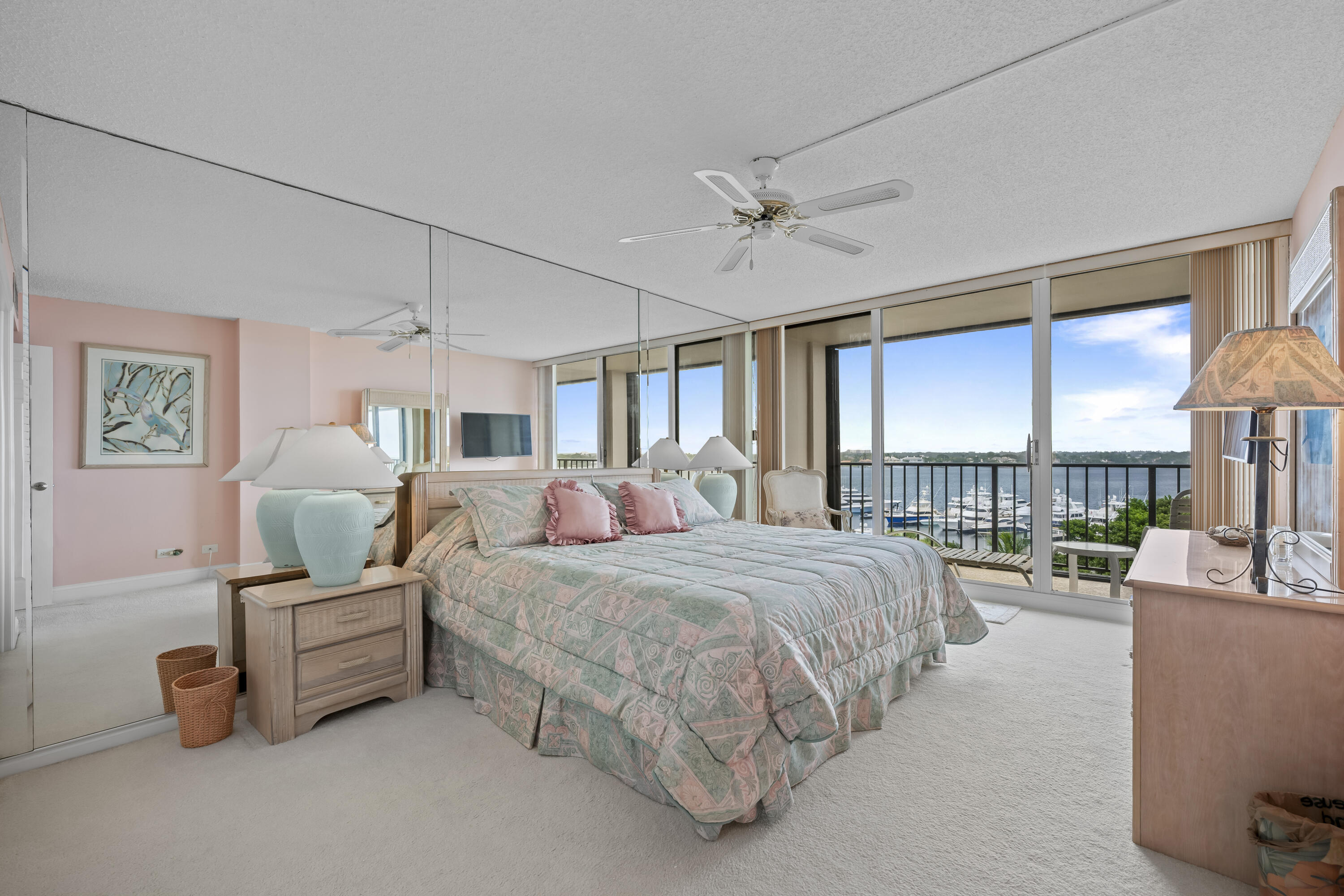 134 Lakeshore Drive, Unit 814 North Palm Beach, FL 33408 - Photo 16 of 30 a bedroom with a bed a chandelier and a large window