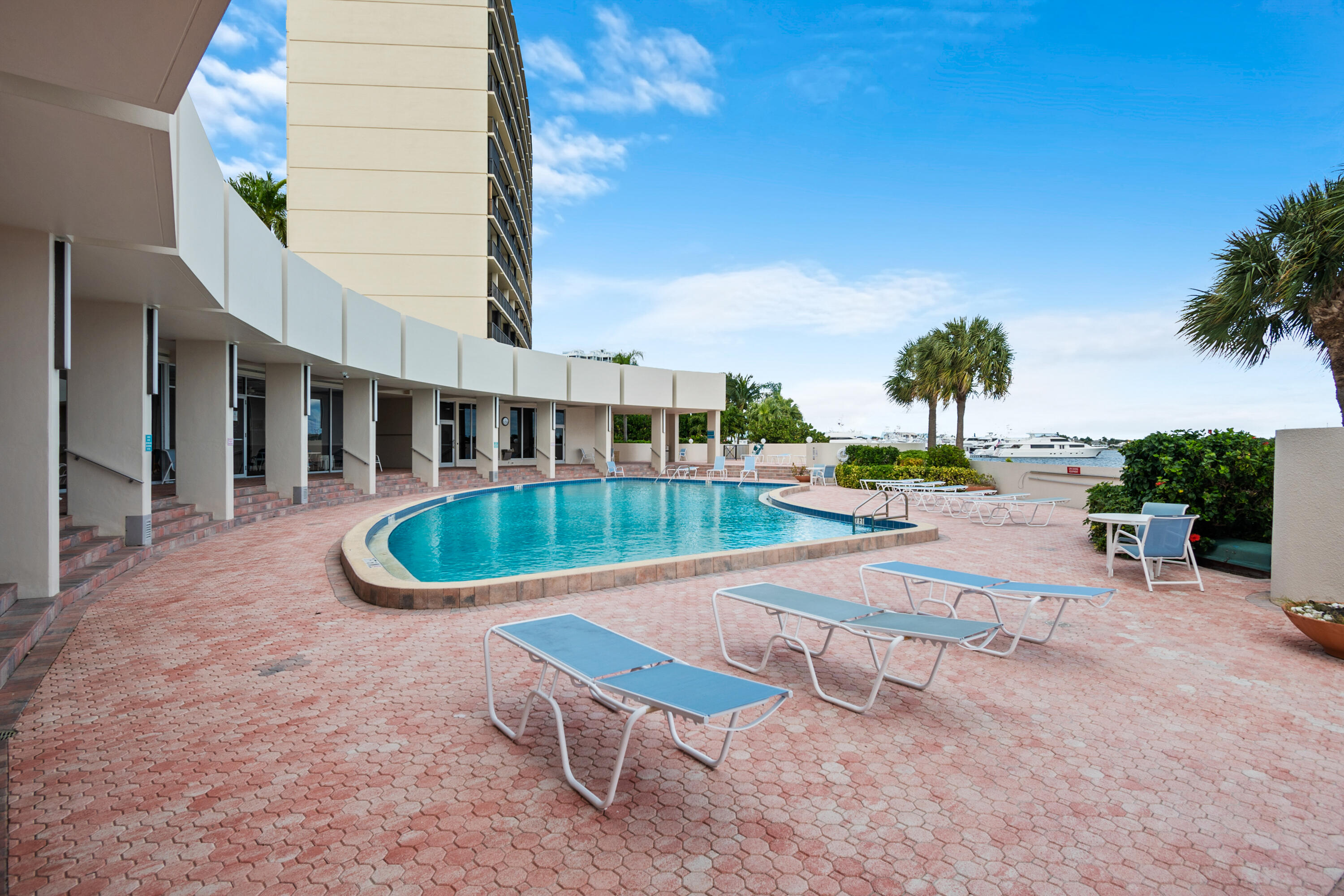 134 Lakeshore Drive, Unit 814 North Palm Beach, FL 33408 - Photo 24 of 30 a view of a swimming pool with a lounge chairs