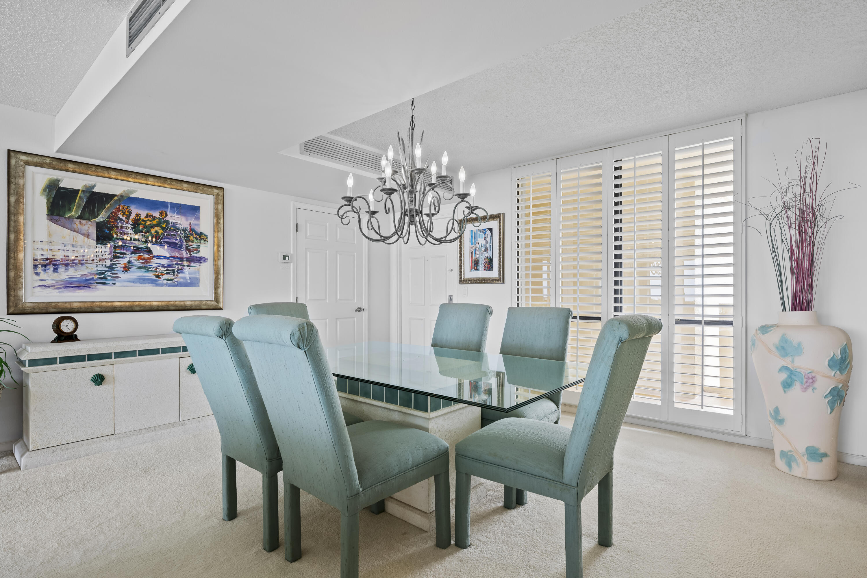 134 Lakeshore Drive, Unit 814 North Palm Beach, FL 33408 - Photo 4 of 30 a view of a dining room with furniture and chandelier