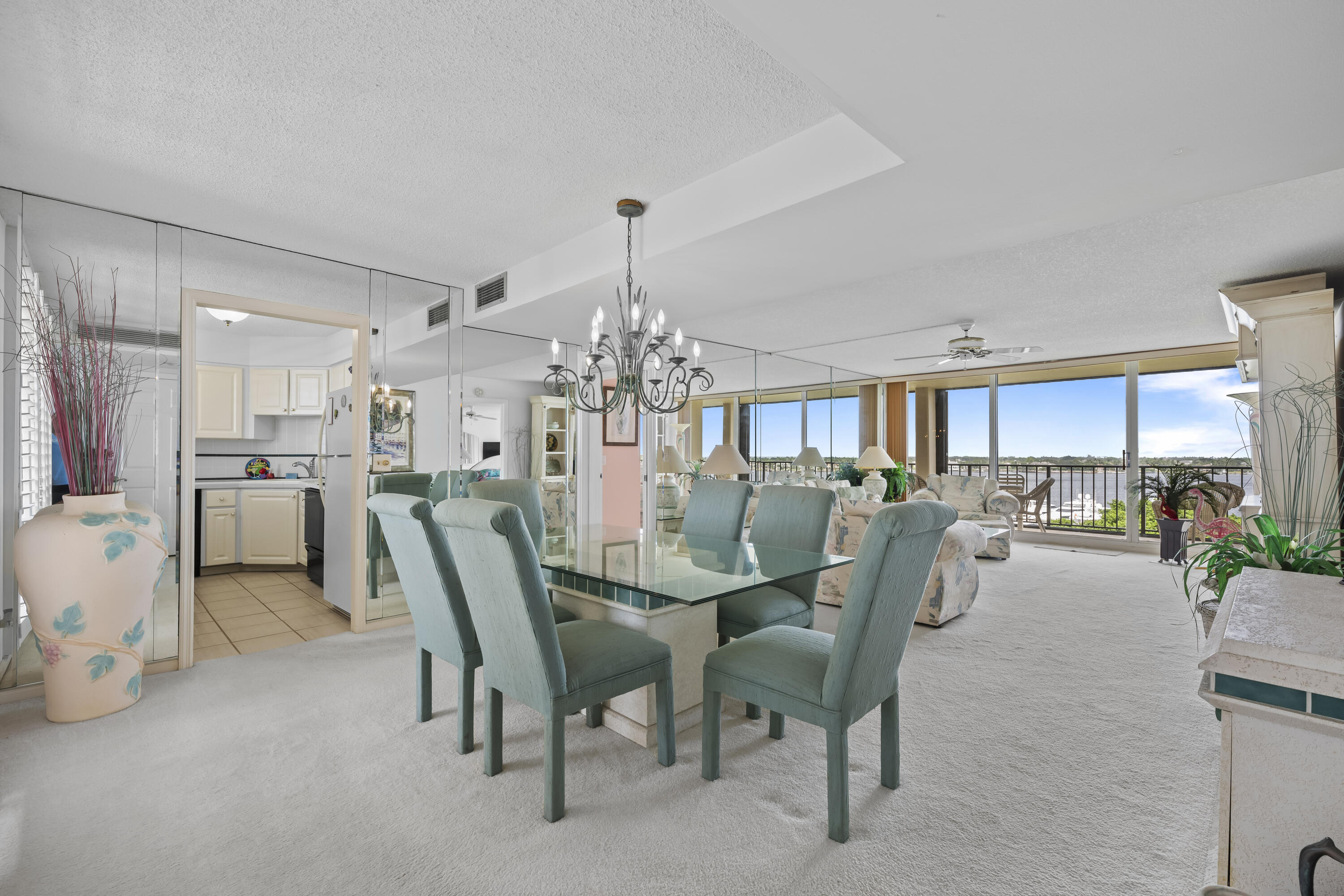 134 Lakeshore Drive, Unit 814 North Palm Beach, FL 33408 - Photo 5 of 30 a view of a dining room with furniture and a chandelier