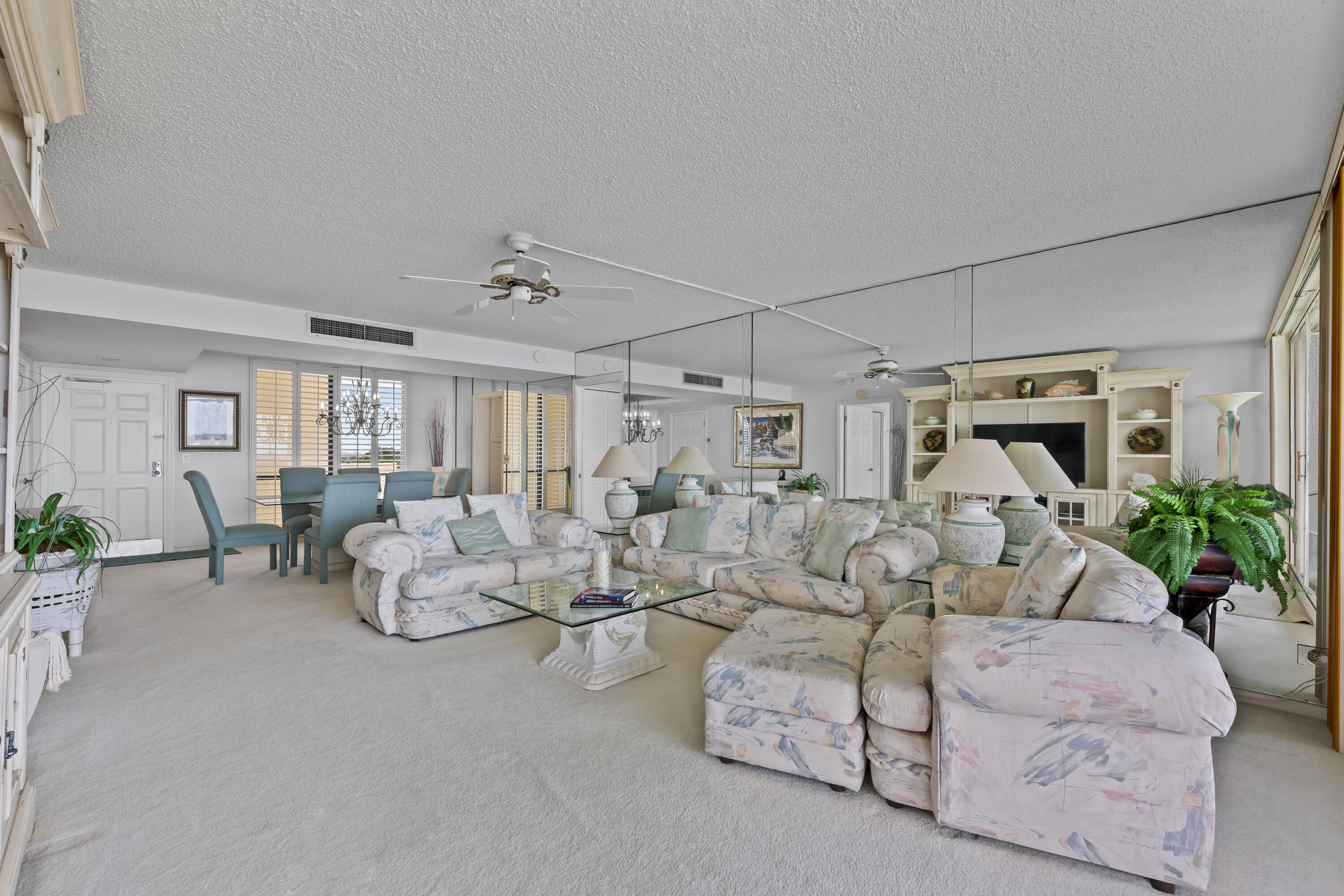 134 Lakeshore Drive, Unit 814 North Palm Beach, FL 33408 - Photo 8 of 30 a living room with patio furniture and flowers