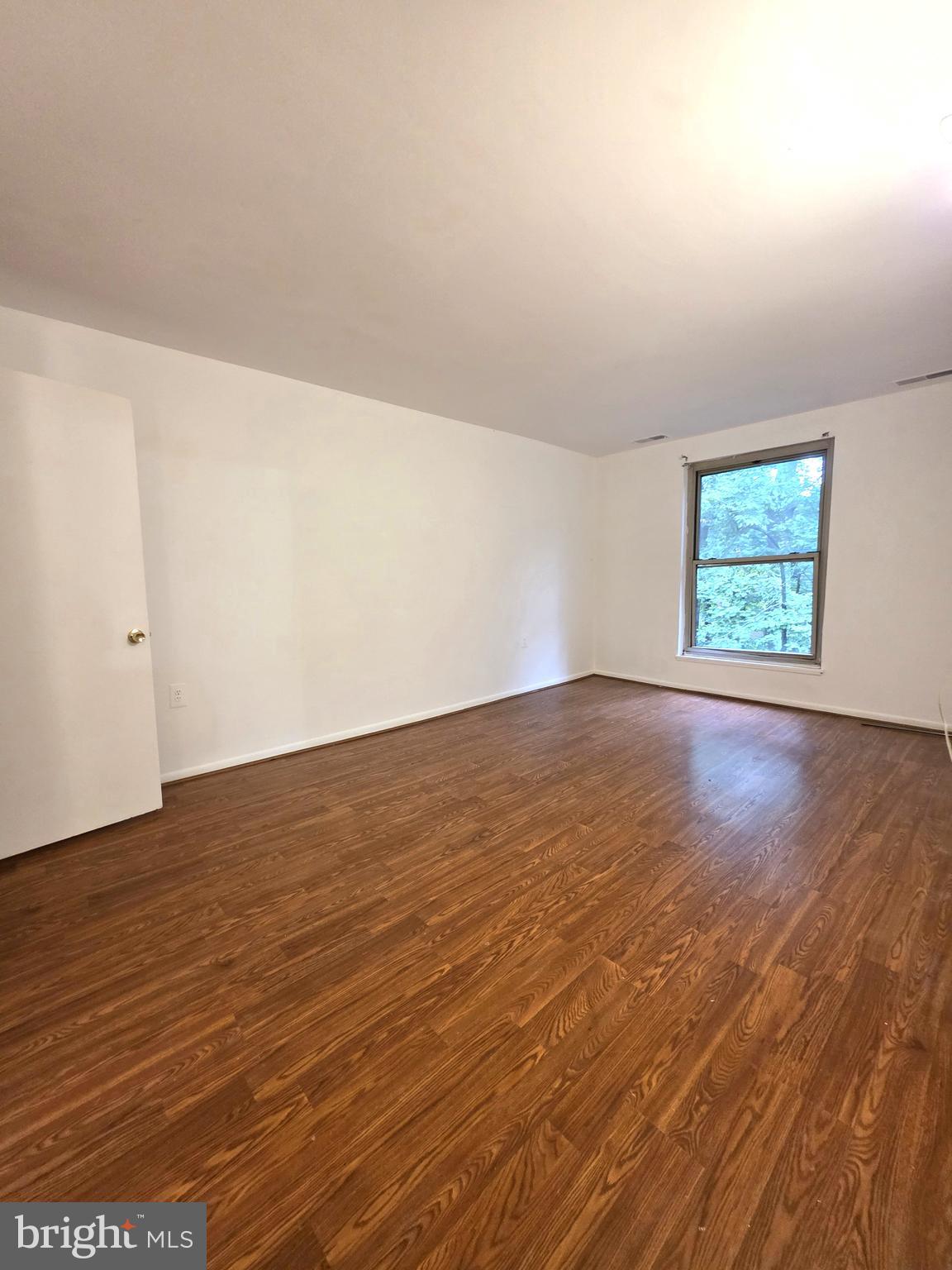 3376 Woodburn Road, Unit 32 Annandale, VA 22003 - Photo 13 of 21 an empty room with wooden floor and windows