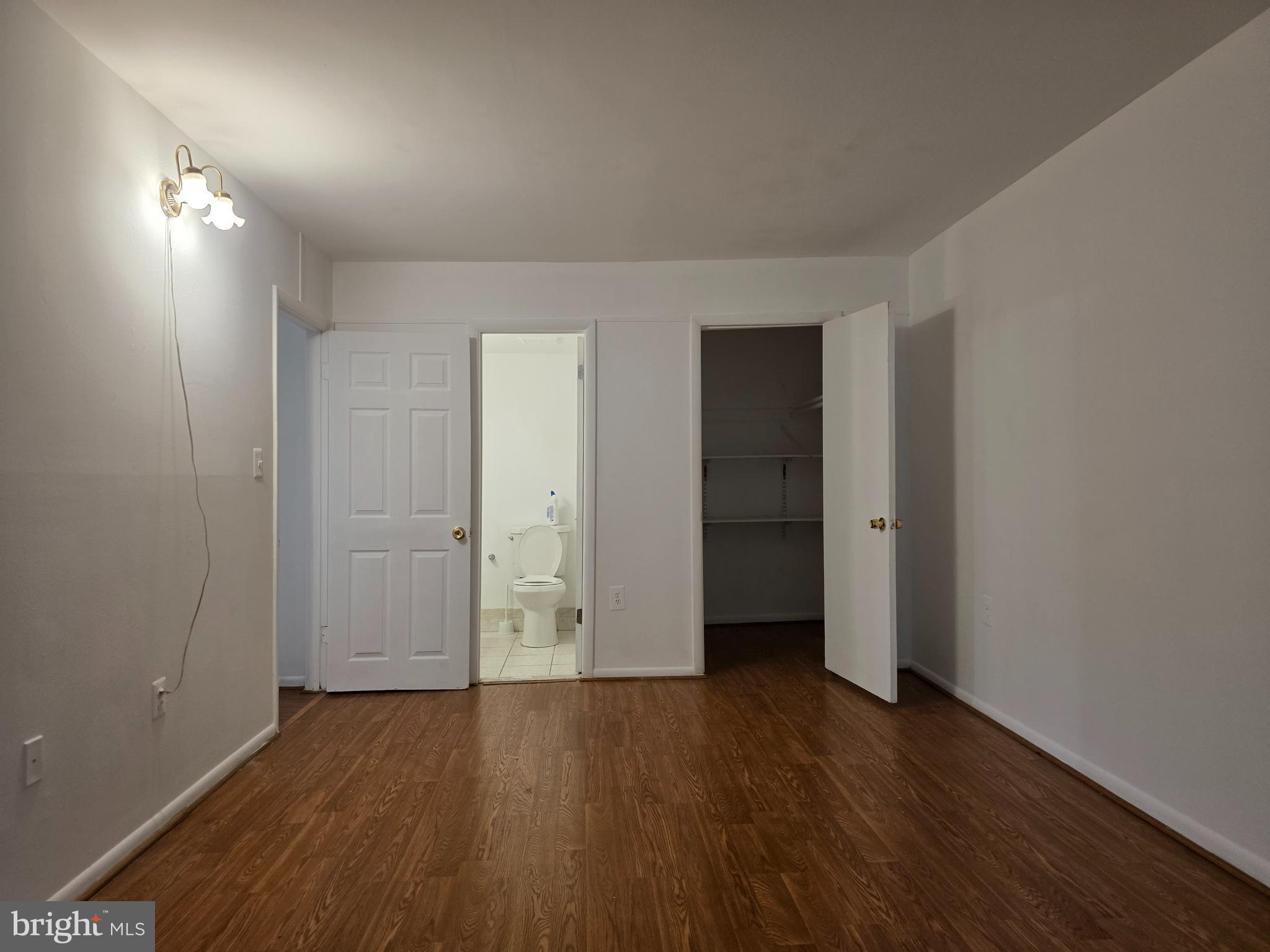3376 Woodburn Road, Unit 32 Annandale, VA 22003 - Photo 15 of 21 an empty room with wooden floor and windows