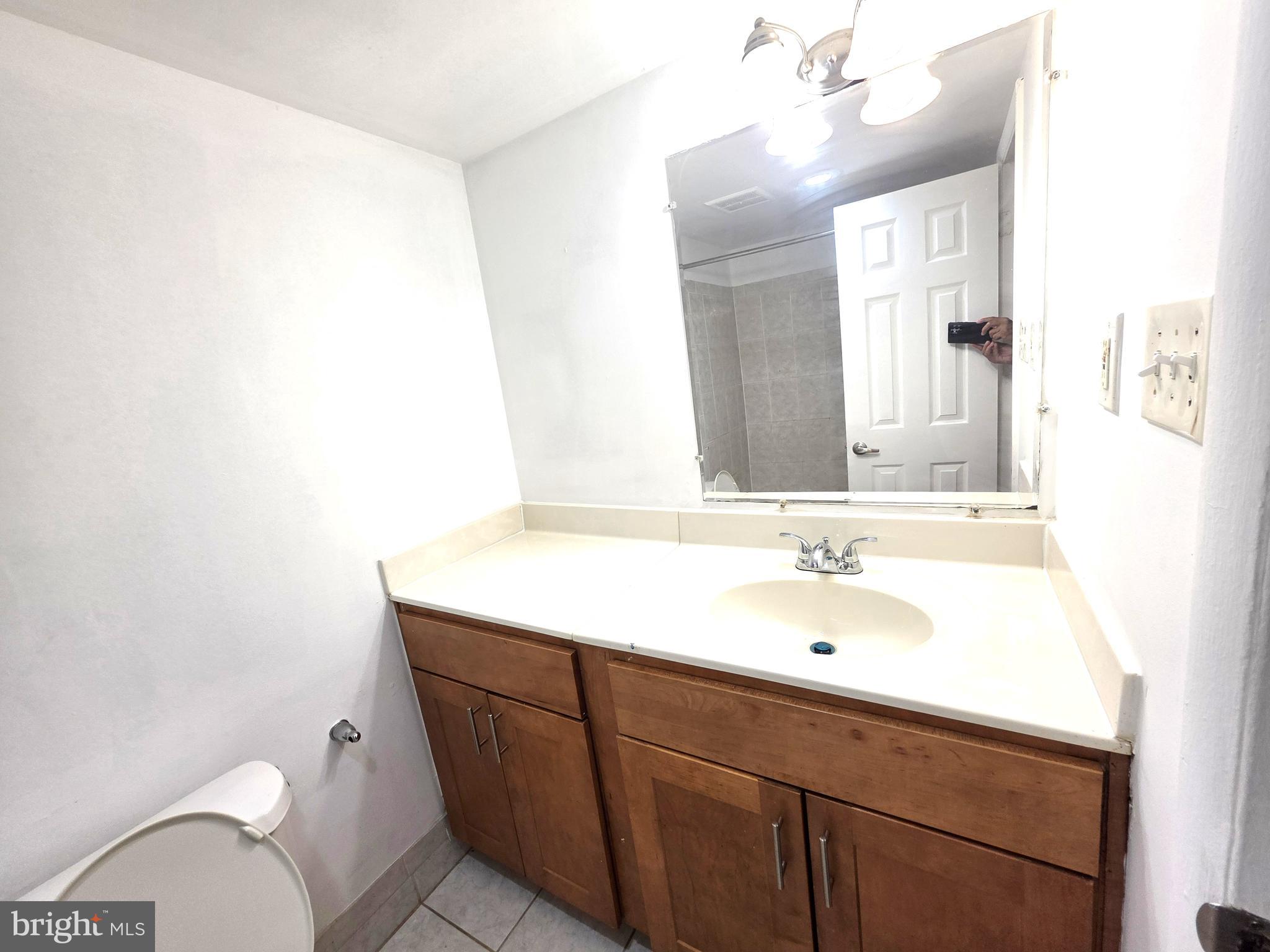 3376 Woodburn Road, Unit 32 Annandale, VA 22003 - Photo 17 of 21 a bathroom with a sink and a mirror