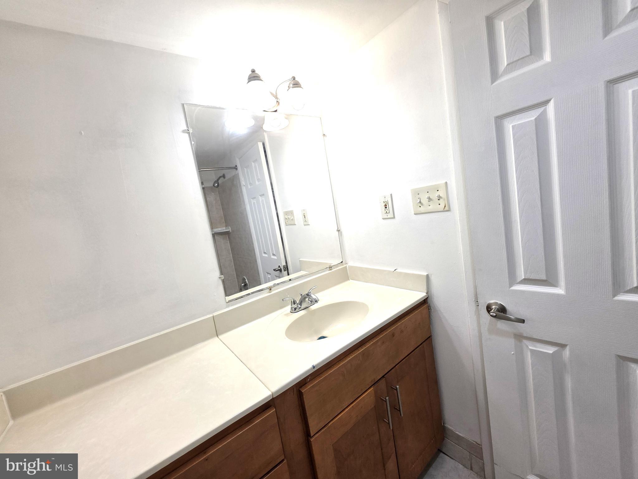 3376 Woodburn Road, Unit 32 Annandale, VA 22003 - Photo 19 of 21 a bathroom with a sink vanity and a mirror