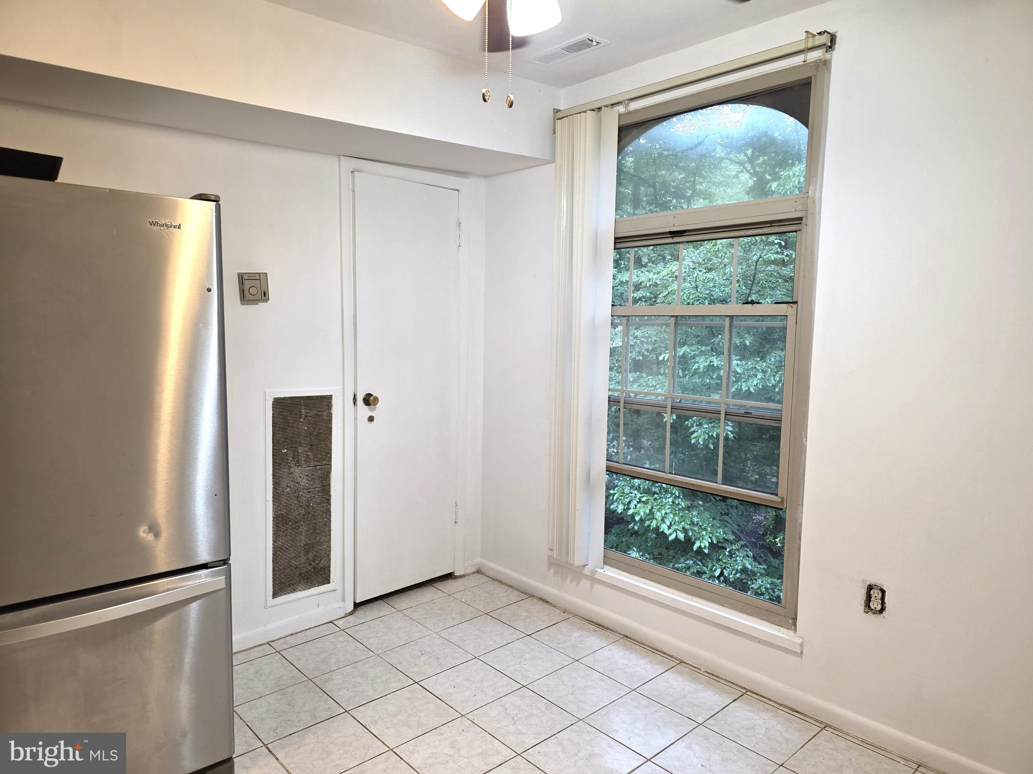3376 Woodburn Road, Unit 32 Annandale, VA 22003 - Photo 4 of 21 a view of hallway with a large window and refrigerator