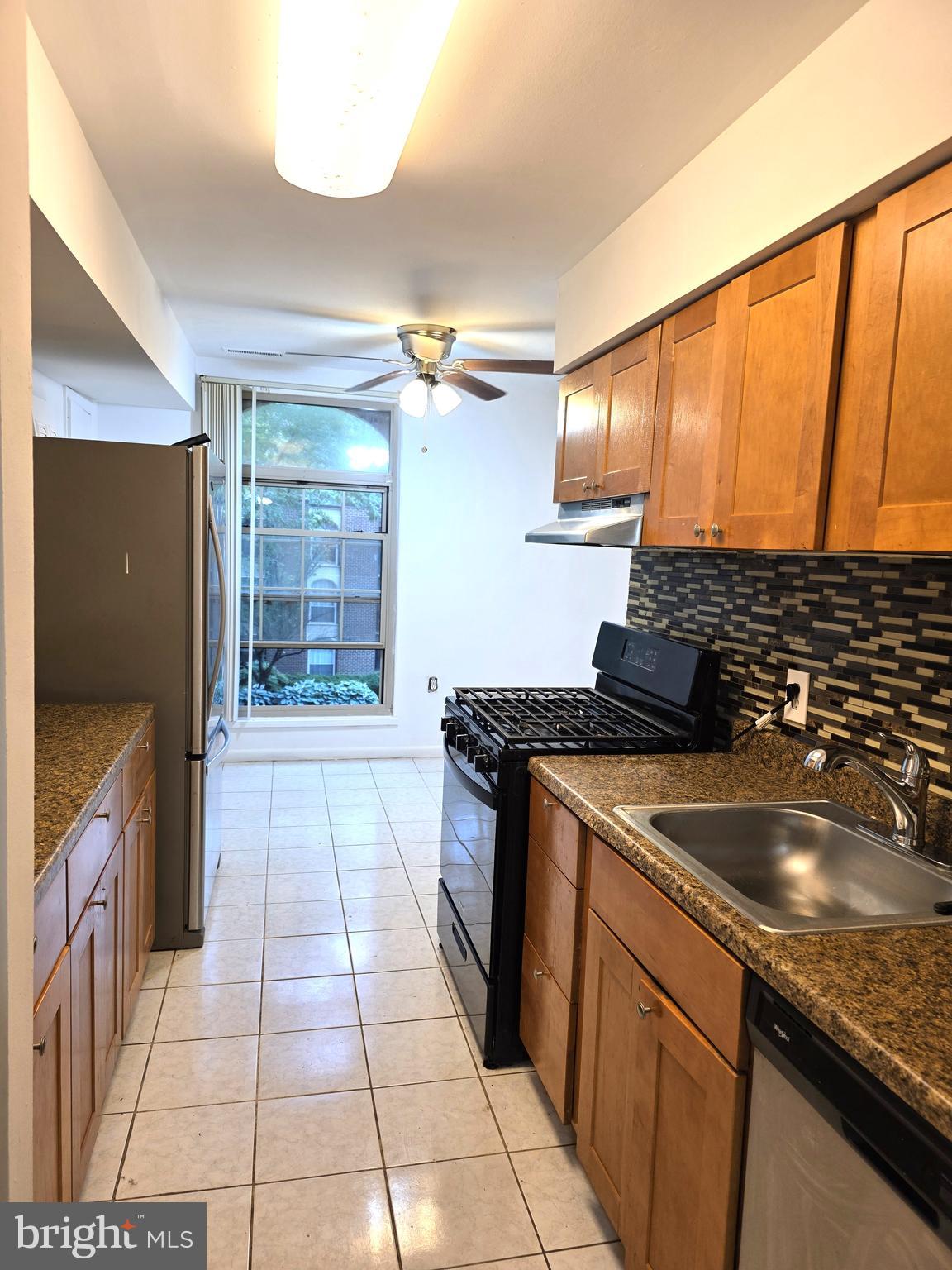 3376 Woodburn Road, Unit 32 Annandale, VA 22003 - Photo 6 of 21 a kitchen with a sink stove and refrigerator