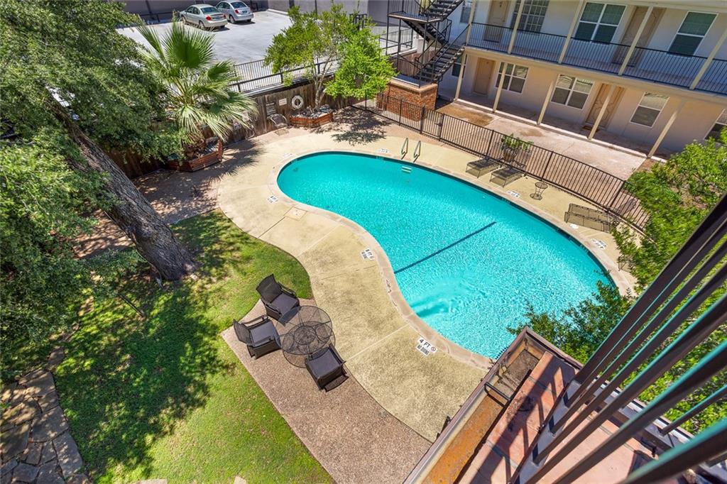 910 Duncan Lane, Unit 35 Austin, TX 78705 - Photo 14 of 20 An inviting community pool beckons on a sunny day, surrounded by lush greenery and concrete paving.