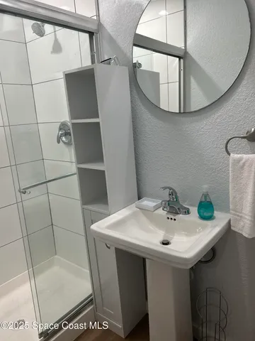 a bathroom with a sink and mirror