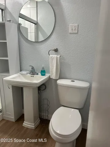 a white toilet sitting next to a bathroom sink