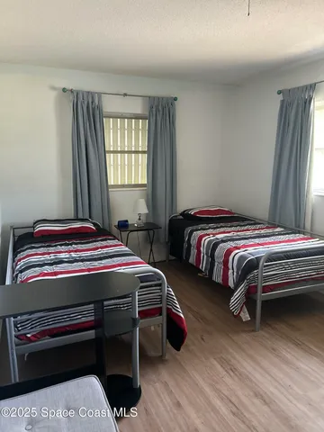 a bedroom with bed and a window