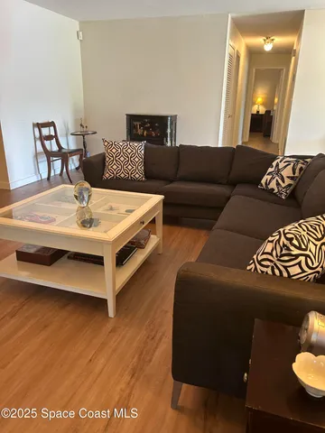 a living room with furniture and a lamp