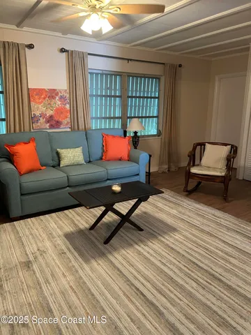 a living room with furniture and a window